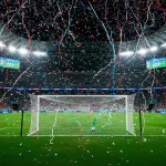 Football stadium scene capturing the moment of a major World Cup upset with celebrating underdog players